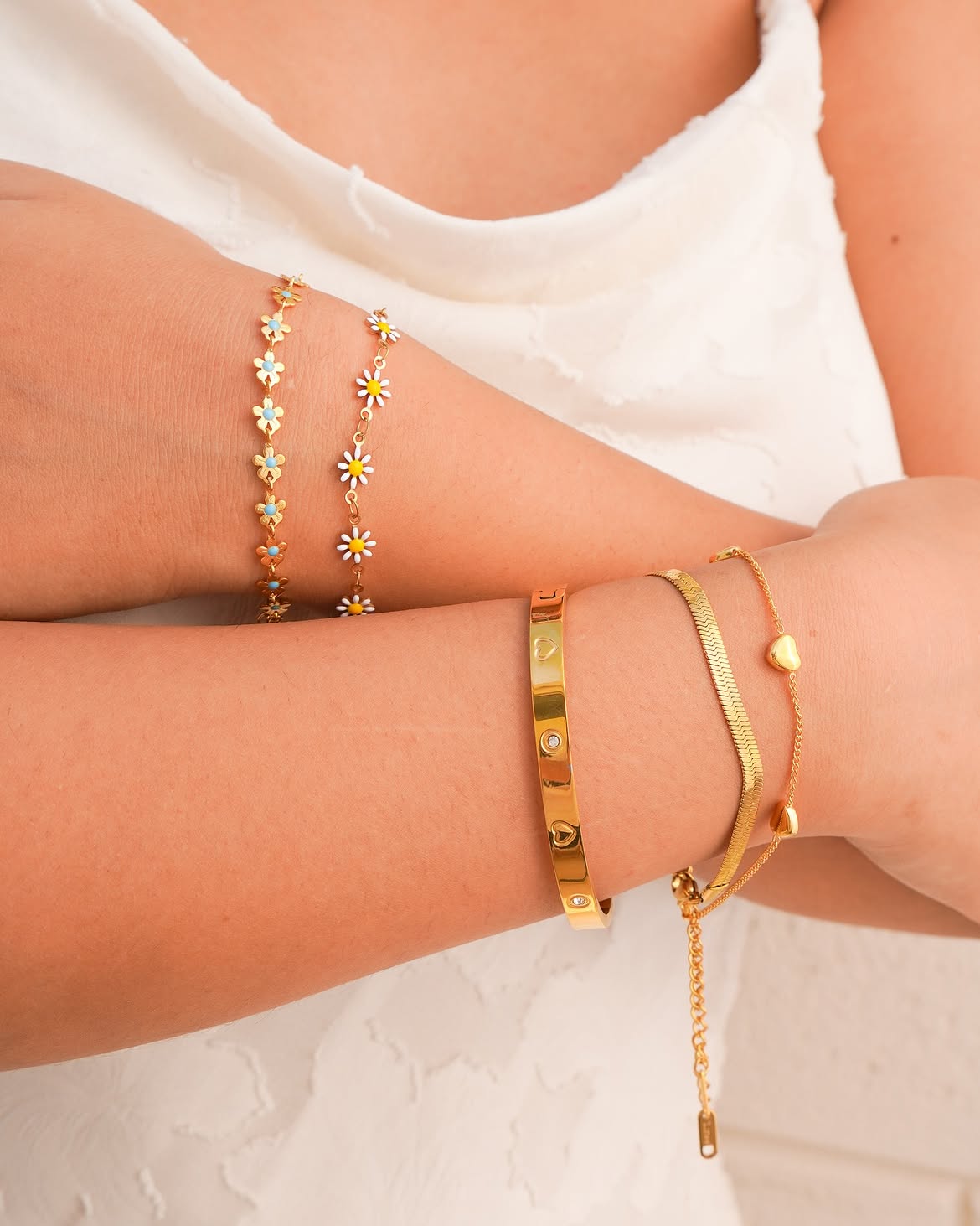 Bracelets and anklets — stacked gold-plated daisy chains, bangle and herringbone bracelets from Banana & Kale