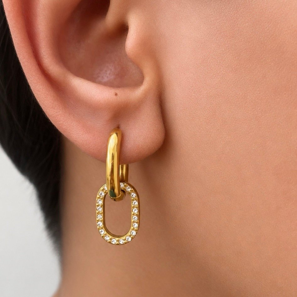 Femme Fatale — gold statement earrings worn on the ear
