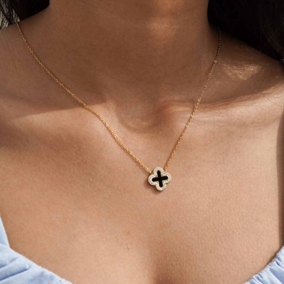Clover Necklace Black — black four-leaf clover pendant in 14k gold-plated stainless steel, front view