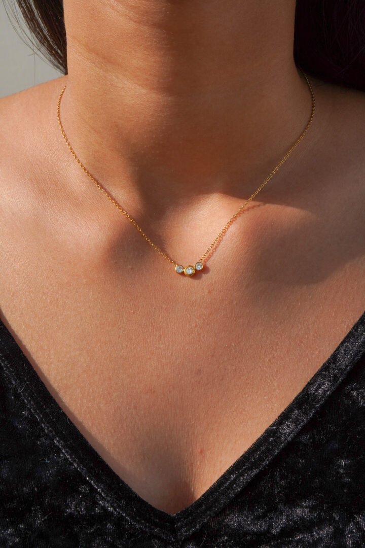 Trix — gold-plated zircon pendant worn layered