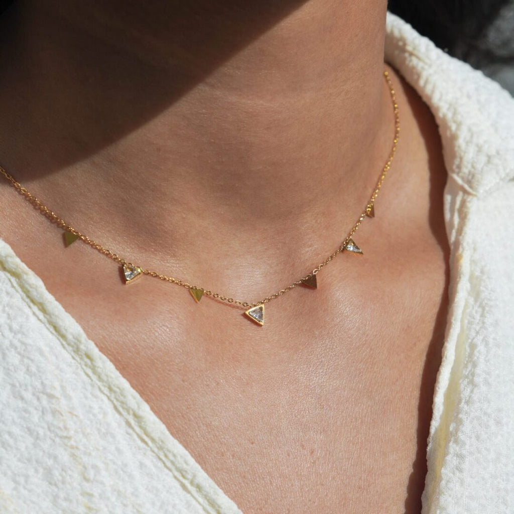 Tiah — gold-plated zircon pendant worn at the collarbone