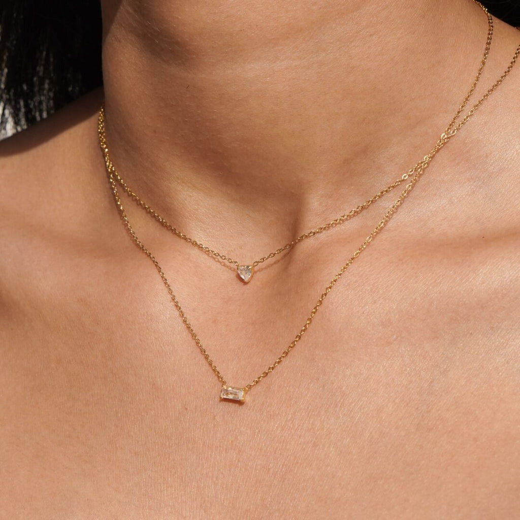 Fate — gold-plated zircon necklace worn at the collarbone