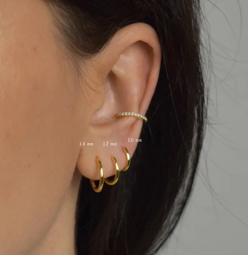 Gold Huggies 10mm — small gold huggie hoops worn on the ear