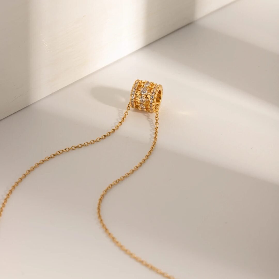 Trinket — zircon charm necklace worn layered