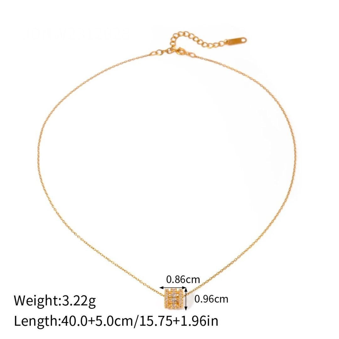 Trinket — close-up of zircon charm on fine gold chain
