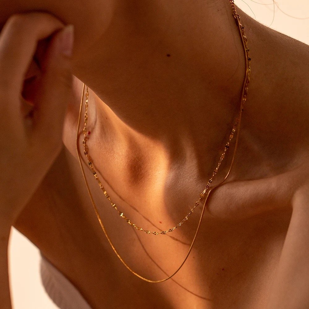 Louis — close-up of gold pendant on fine chain