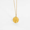 Insurgent — flat disc pendant necklace in 18k gold-plated stainless steel, front view