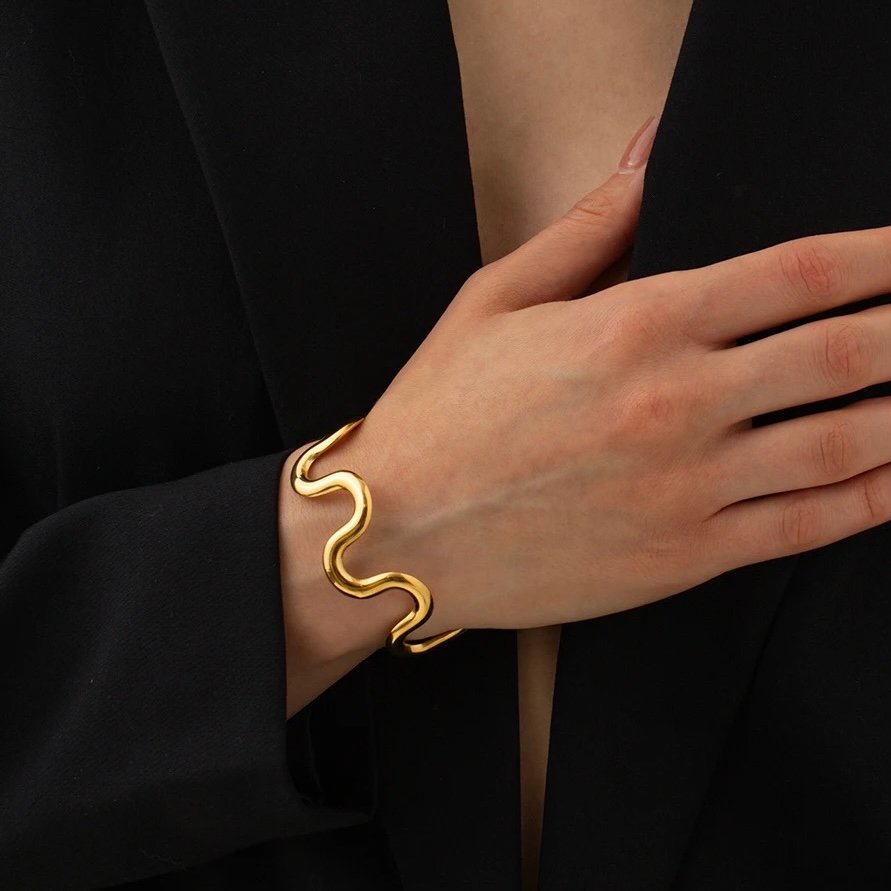Wave Cuff — gold wave cuff worn on the wrist