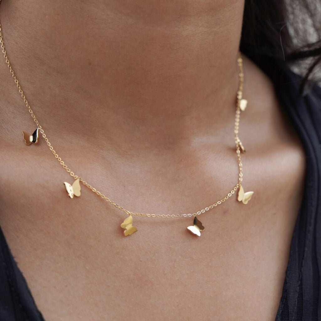 Mariposa — butterfly charm necklace styled layered