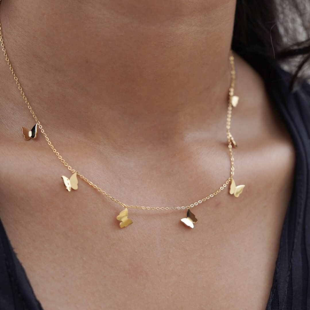 Mariposa — butterfly charm necklace styled layered