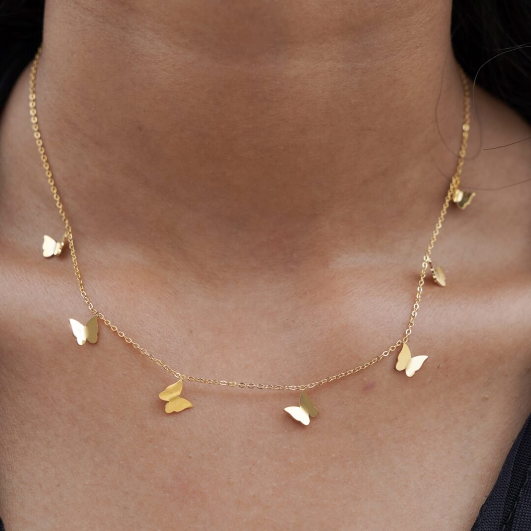 Mariposa — gold-plated butterfly necklace worn at the collarbone