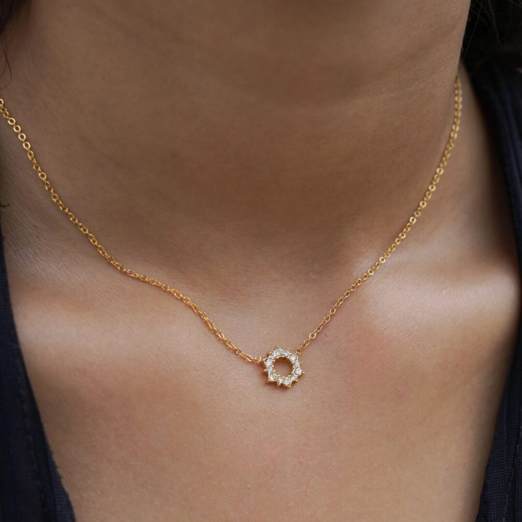 Halo — gold-plated zircon halo pendant worn at the collarbone