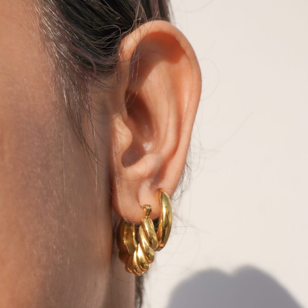 Croissant Hoops — gold-plated chunky hoop earrings, flat lay