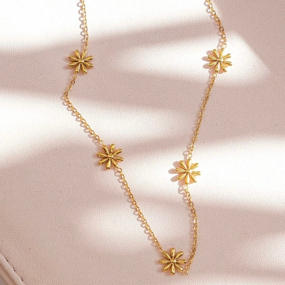 Petite Daisies — close-up of daisy charms on fine gold chain
