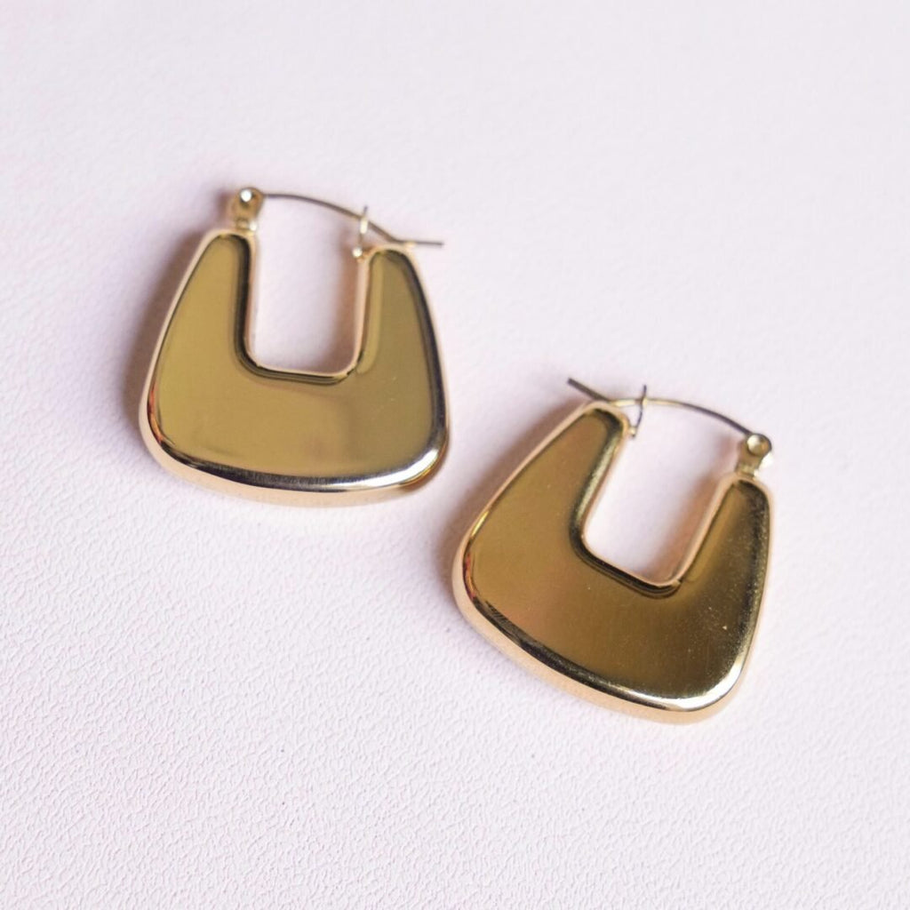 Bianca Hoops Gold — gold hoop earrings styled on model