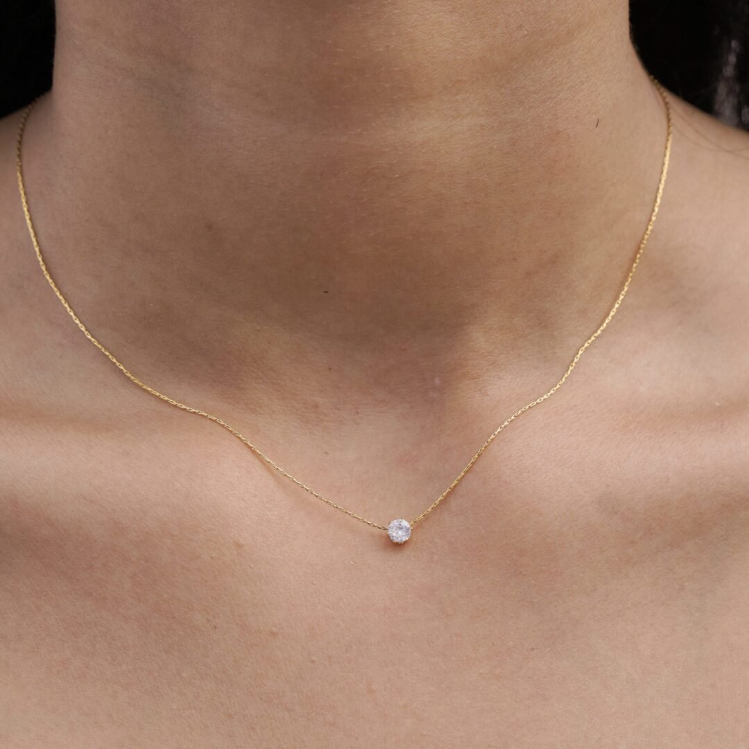 Glitz — gold-plated zircon necklace worn at the collarbone