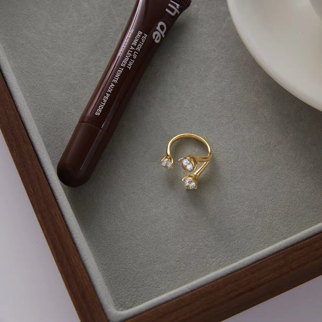 Trinity — woven band ring styled on the hand