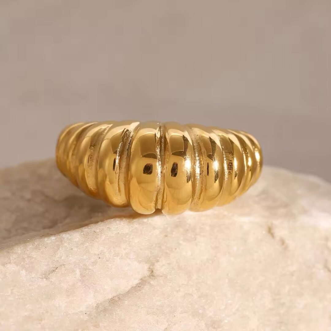 French Twist — gold rope ring styled on the hand