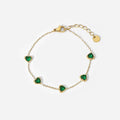 Emerald Hearts — green zircon heart bracelet in 14k gold-plated stainless steel, front view