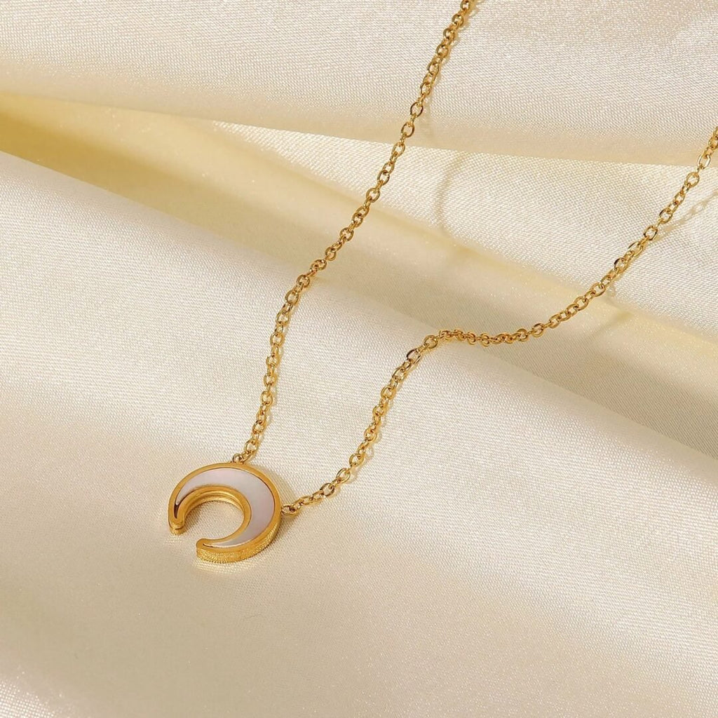 White Moon — close-up of round white shell stone in gold-plated setting