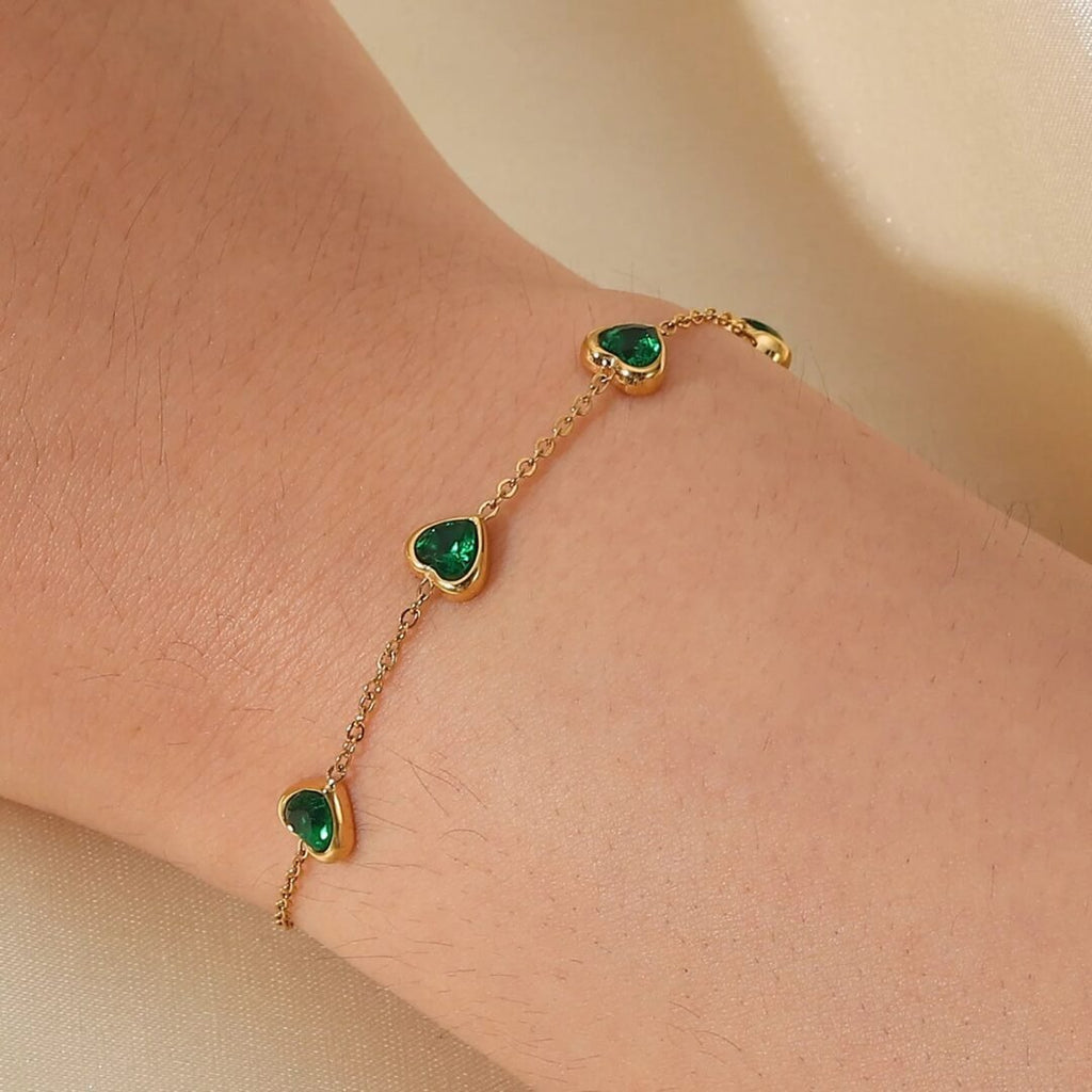 Emerald Hearts — green stone heart bracelet worn on the wrist
