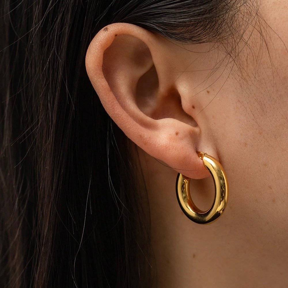 Tube Hoops Medium — gold-plated tube hoops worn on the ear