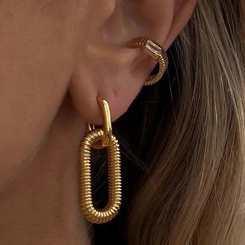 Lexie Earrings Gold — close-up of gold drop earring
