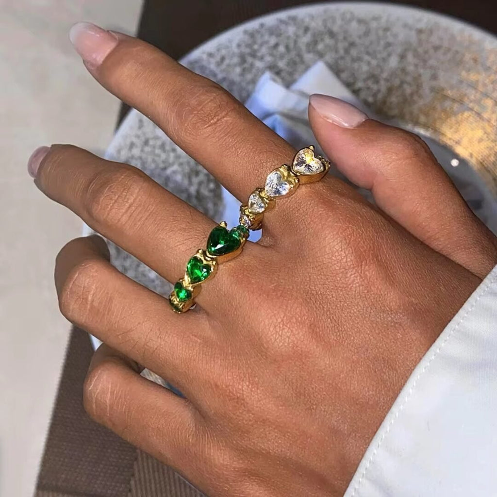 White Hearts Ring — gold band with white hearts, flat lay