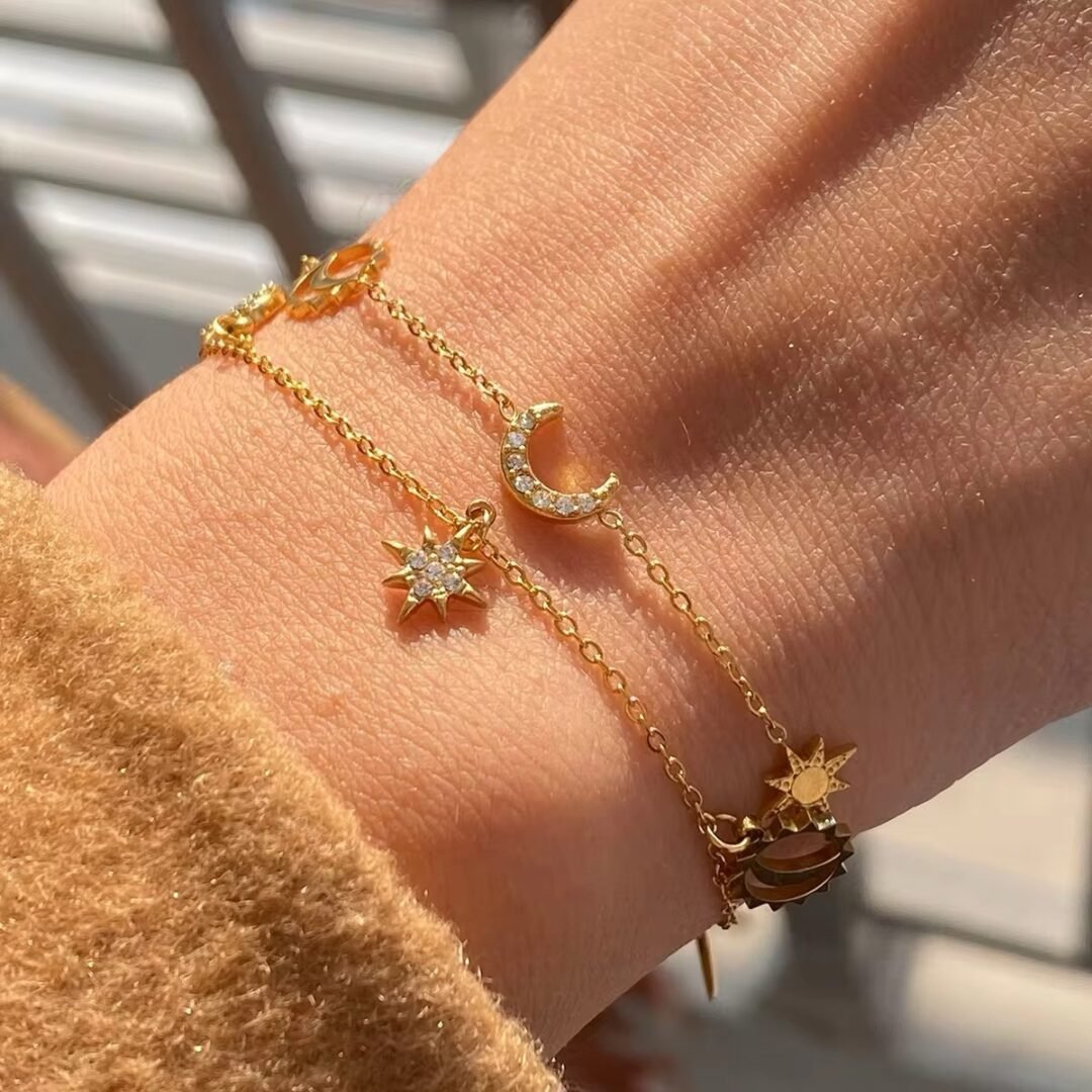 Cosmic Charm Bracelet — celestial zircon charm bracelet in 18k gold plating, front view