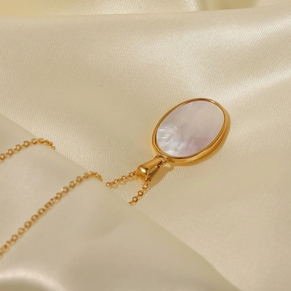 Sunrise — gold-plated sun pendant and chain, flat lay