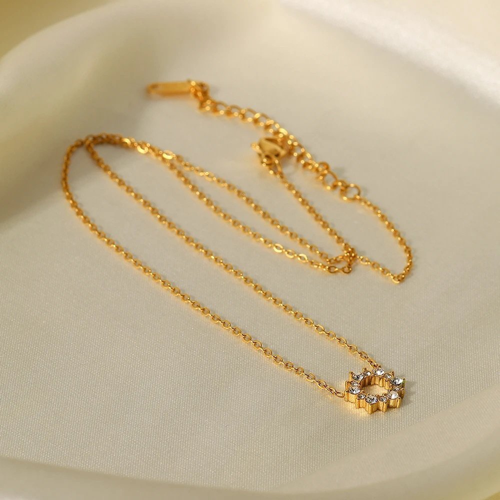 Halo — close-up of circular zircon setting on gold-plated pendant